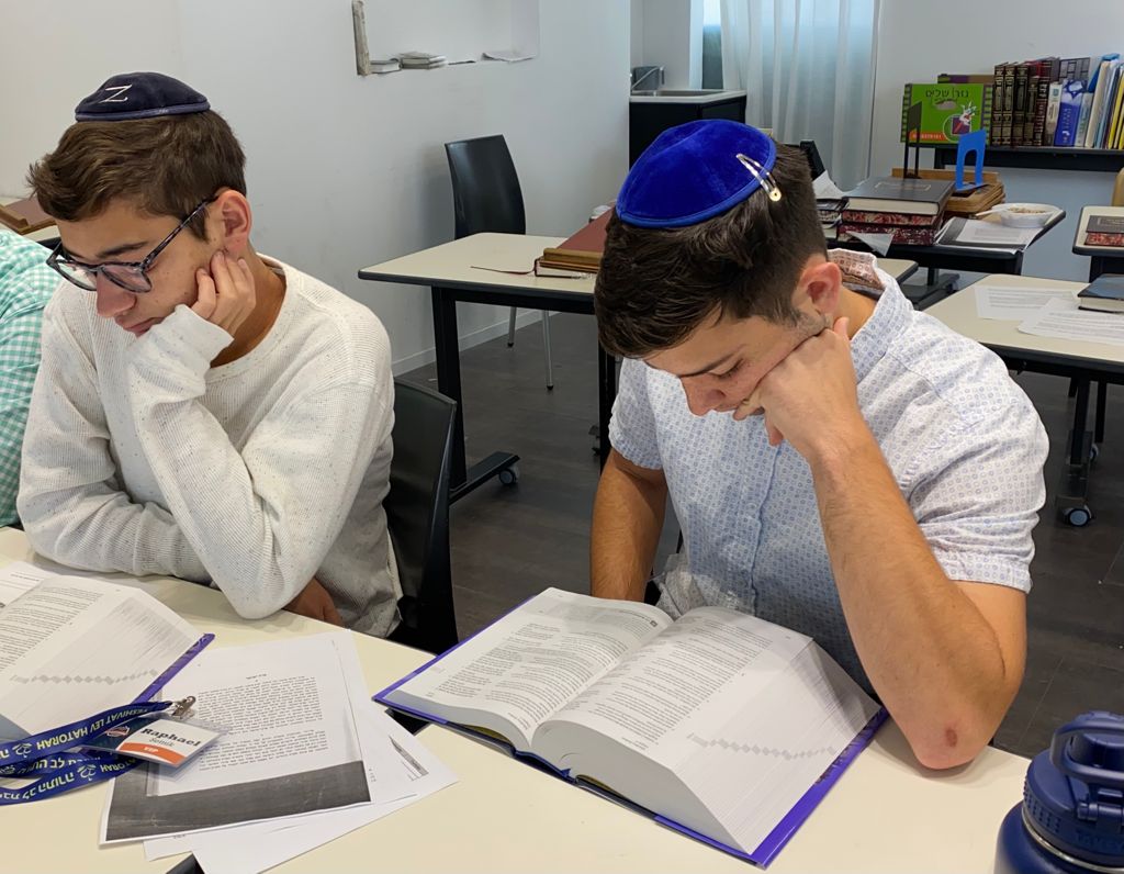 Yeshiva students studying "The Israel Bible"